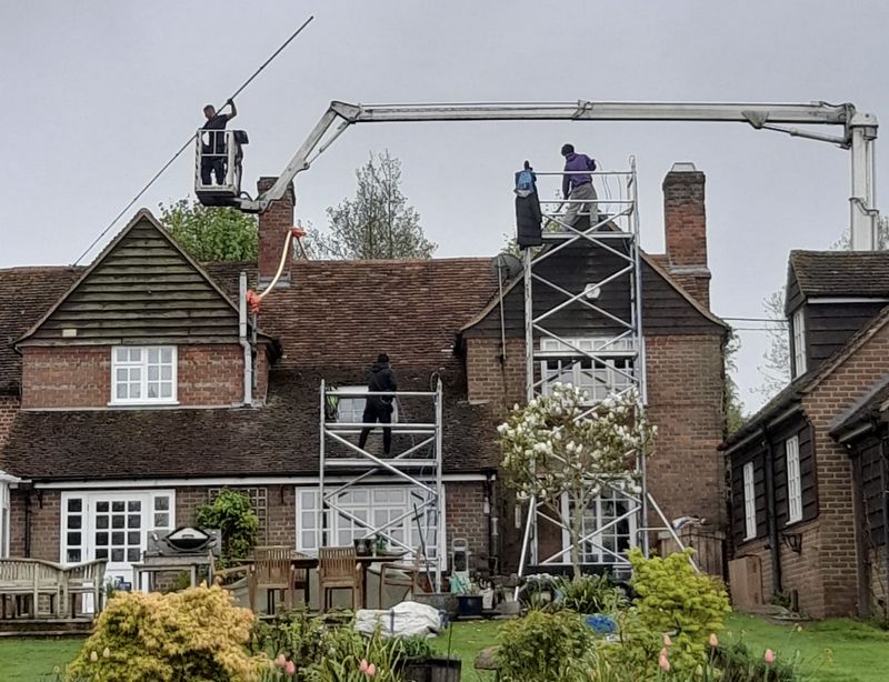 The Moss Cleaners using cherry picker and scaffolding to clean roof safely and professionally in 77 Chipstead Valley Rd, Coulsdon CR5 3BP, UK, 77 Chipstead Valley Rd, Coulsdon CR5 3BP, UK
